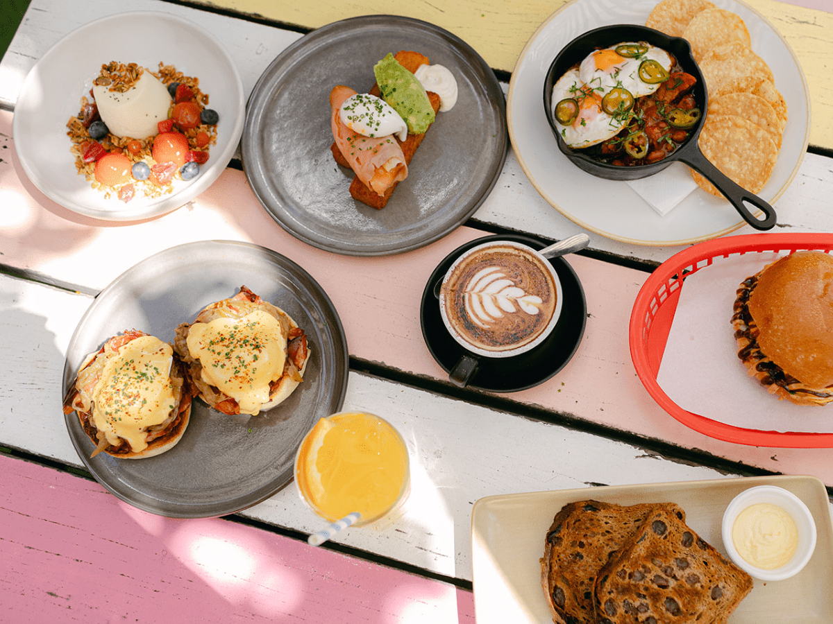 a table with plates of food and drinks