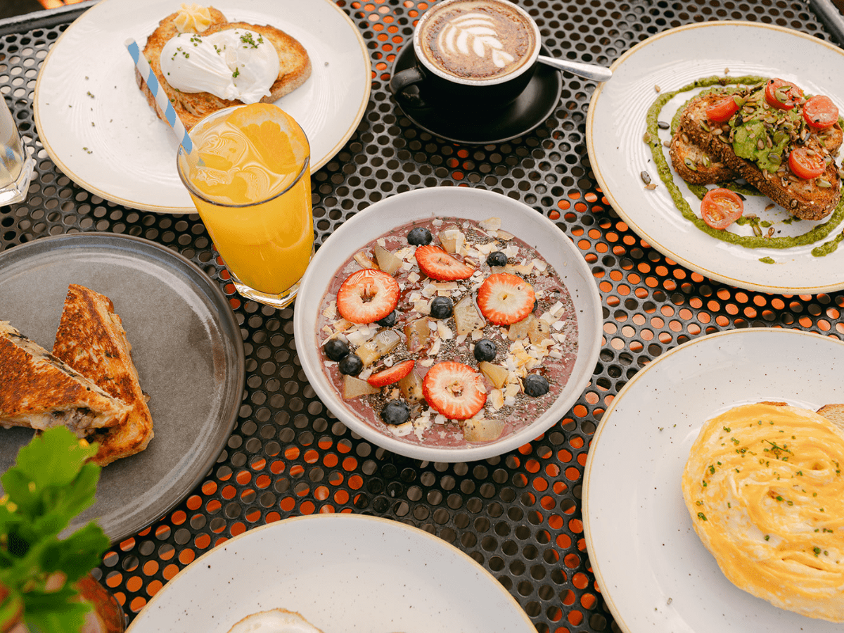 a table with plates of food and drinks