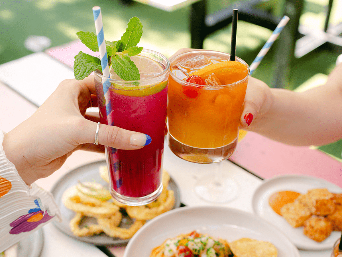 a pair of hands holding drinks